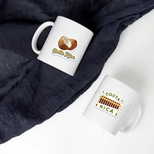 Detail of two white ceramic Costa Rica travel mugs with vibrant tropical prints