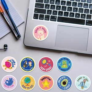 Close-up of circular colorful reward stickers with animal cartoons and English slogans