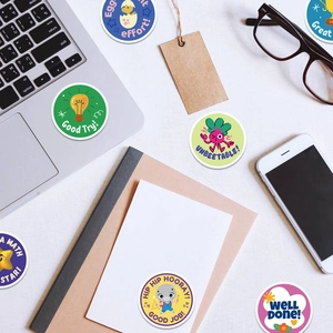 Scene showing colorful round motivational animal reward stickers on a desk for kids
