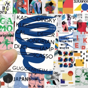 Detailed macro view of Bauhaus art stickers featuring blue spiral patterns and artist names
