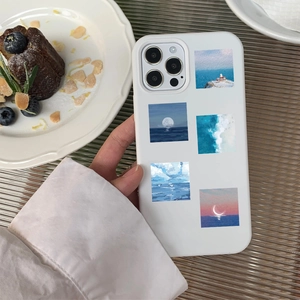 Handheld iPhone case with five artistic oil painting stickers of lighthouse and seascapes