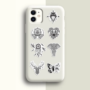 Detail of gothic black and white animal stickers on a matte white silicone phone case