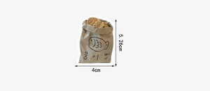 Detail shot of hand-drawn Taiyaki fish cake stickers in a paper bag with 4cm size dimensions