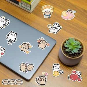 Close-up of cute cartoon squirrel stickers decorating a laptop on a cozy wooden desk