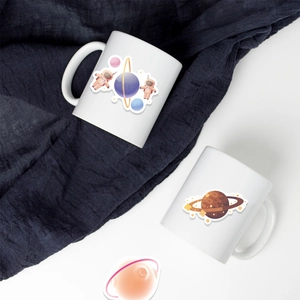Detail view of the astronaut planet printed ceramic mug featuring a C-shaped handle