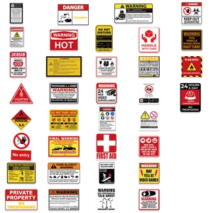 Macro view of assorted PVC warning and safety stickers with industrial icons and text