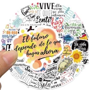 Detail showing a person holding a Spanish motivational sticker with sunflowers and cute art