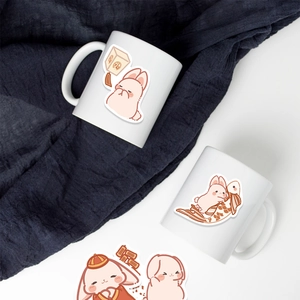 Close-up of cute festive rabbit stickers on a white ceramic mug with high angle view