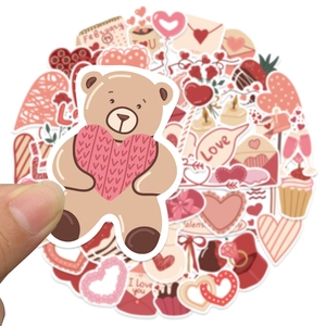 Close-up of heart stickers for Valentine's Day decor on notebooks and cups