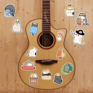 Macro shot of cute cartoon cat stickers on an acoustic guitar for creative DIY decoration