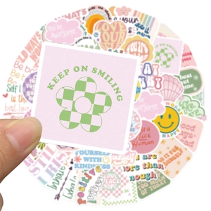 Close-up of waterproof Danish-style pastel stickers with positive quotes and retro patterns