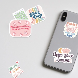 Detail view of Danish style stickers on a smartphone showing inspirational phrases
