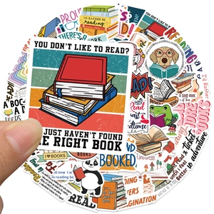 Close-up of creative reading stickers with animal illustrations and quotes for laptops
