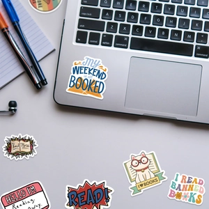 Macro view of book theme waterproof stickers on a laptop with reading slogans and cat icons