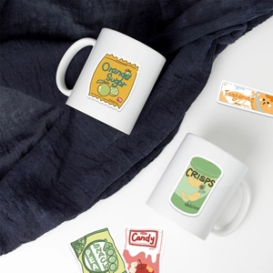 DIY cartoon snack stickers on white ceramic mugs with orange and crisp designs