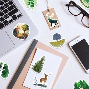 Creative forest and animal stickers on a laptop and notebook for a scenic stationery setup