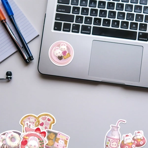 Close-up of cute pink rabbit stickers showing die-cut edges on a laptop surface