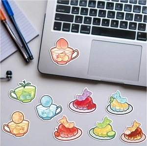 Detailed stickers showing cute cartoon cats mixed with jelly and dessert on a laptop