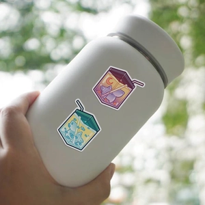 Detail of waterproof cartoon juice stickers on a matte bottle with cat and moon patterns