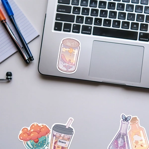 Cute cartoon beverage stickers showing colorful cups on a silver laptop surface