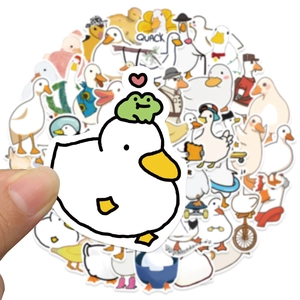 Close-up of waterproof cartoon duck sticker held by fingers featuring cute yellow animal designs