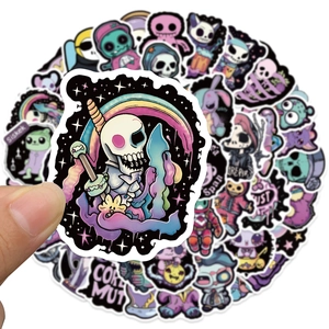 Close-up of creepy cute purple goth stickers showing detailed skull and monster designs
