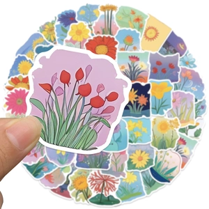 Close-up of hand holding a colorful floral tulip sticker from a decorative set