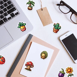Flat lay of pixel art fruit and vegetable stickers on a laptop and smartphone background