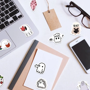 Collection of 100 cute cartoon ghost stickers on a laptop and notebook for Halloween decoration