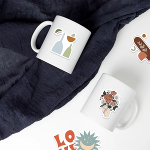 Detail of BOHO art stickers with floral and geometric designs on a ceramic mug