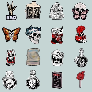 Gothic enamel pin set with skull butterfly and heart designs in black white and red colors