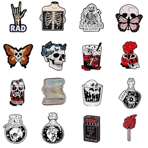 Set of 15 gothic enamel pins featuring skeletons and dark butterfly designs on white background
