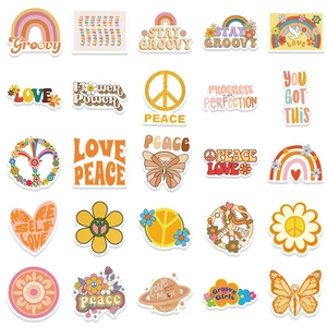 Flat lay of retro 70s BOHO stickers with rainbows and floral designs on white background