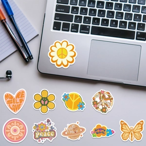 Detail showing waterproof BOHO art stickers with hippie patterns on a laptop and water bottle