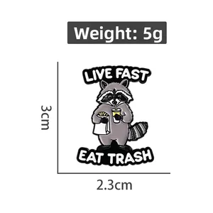 Detailed dimensions of a cartoon raccoon enamel pin with Live Fast Eat Trash text