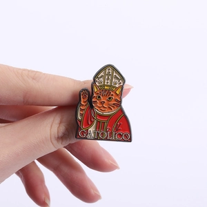 Detail view of cat godfather enamel pin with Gatolico text and gold ecclesiastical robes