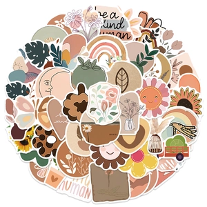 Flat lay of earth-toned BOHO stickers with floral patterns and rainbows on white background