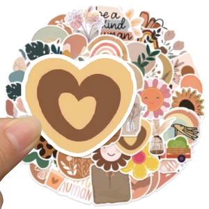Close-up of waterproof BOHO style matte stickers with earth tone rainbow and floral patterns