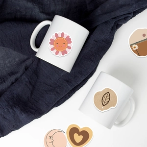 Close-up of waterproof BOHO art stickers on a white ceramic mug with floral patterns