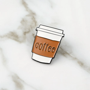 Minimalist coffee cup enamel pin brooch with coffee text on marble background