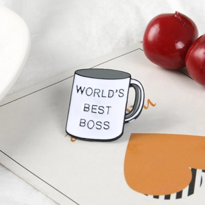 Enamel tea cup brooch featuring World's Best Boss text in classic white ceramic style