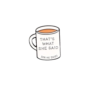 Enamel coffee cup brooch with 'THAT'S WHAT SHE SAID' slogan on a white background
