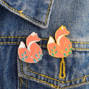 Cute cartoon red fox enamel pins in gold and silver alloy finish on denim jacket