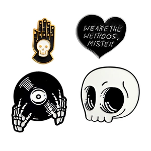 Detailed set of 4 gothic enamel pins featuring skull motifs and skeleton hands