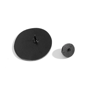 Detail view of the black matte enamel pin back and rubber clutch fastener set