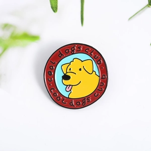 Detail of a round enamel cool dogs club pin featuring a yellow cartoon dog on blue