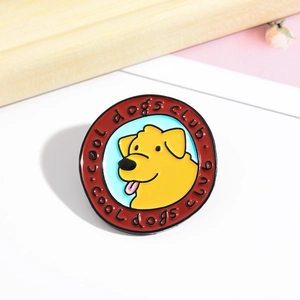 Detail of a round enamel pin featuring a cute cartoon dog and Cool Dogs Club text