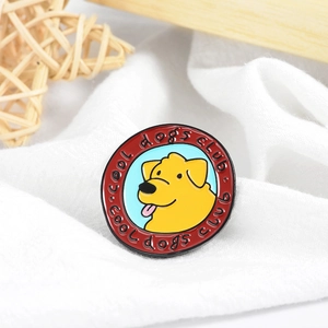 Detail of a round enamel cool dogs club brooch featuring a yellow puppy on white fabric