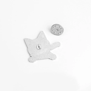 Detailed view of the silver alloy cat badge back with butterfly clutch and textured finish