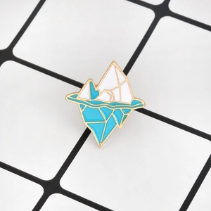 Minimalist geometric iceberg enamel brooch pin featuring blue and white ocean wave design